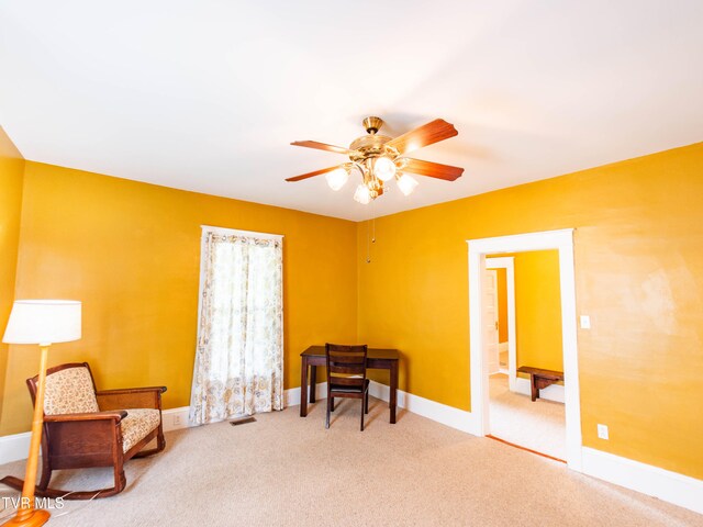 sitting room featuring ceiling fan and light carpet