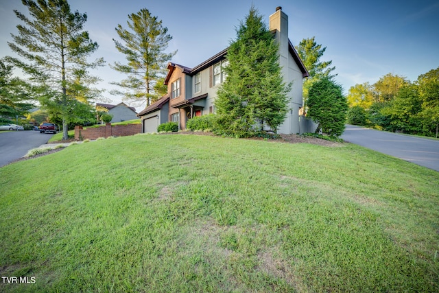 view of front of house featuring a front yard and a garage