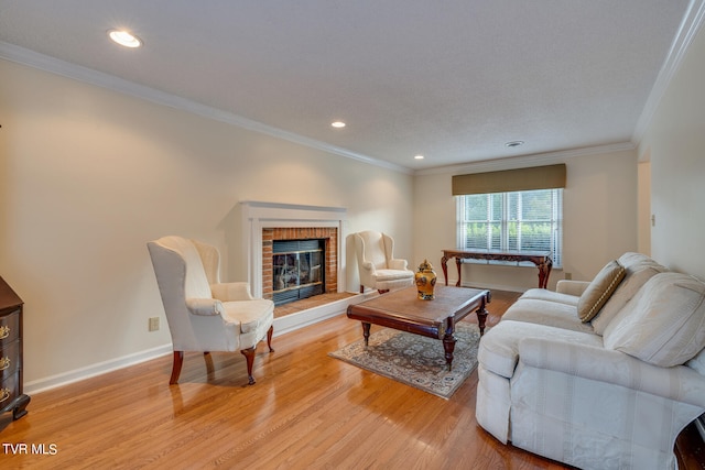 living room with light hardwood / wood-style flooring, crown molding, and a brick fireplace