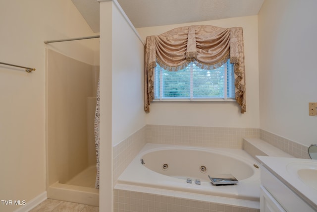 bathroom featuring shower with separate bathtub, tile patterned flooring, a textured ceiling, and vanity