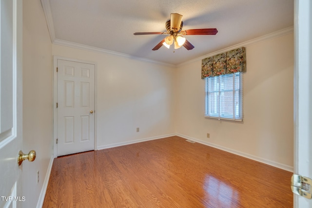 unfurnished room featuring ceiling fan, hardwood / wood-style floors, and crown molding