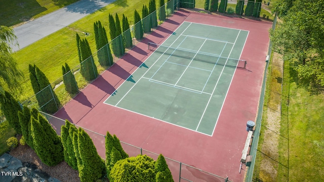 view of tennis court featuring a lawn