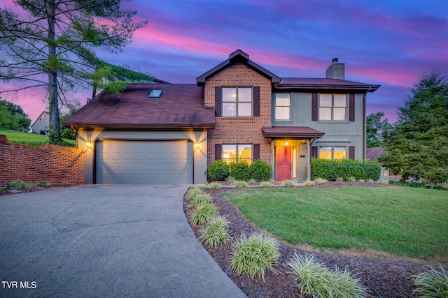 view of front of property featuring a lawn and a garage