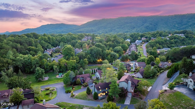 aerial view at dusk featuring a mountain view