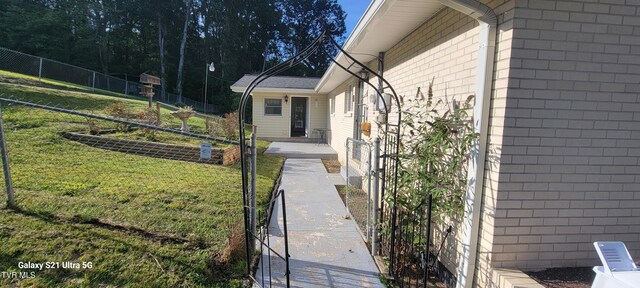 view of side of property with a yard