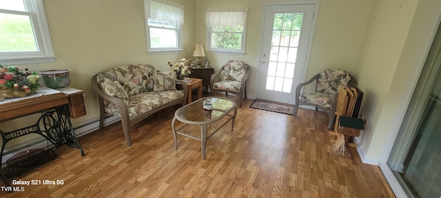 living area featuring baseboards and light wood finished floors