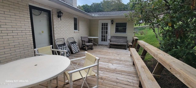 wooden terrace featuring outdoor dining area