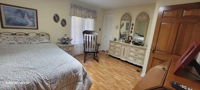 bedroom featuring visible vents and light wood-style flooring