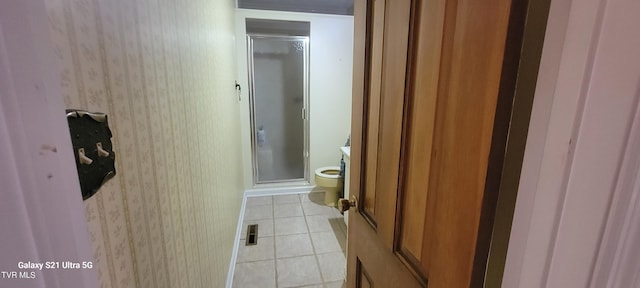 bathroom featuring wallpapered walls, tile patterned floors, and a stall shower