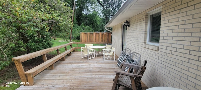 wooden terrace featuring outdoor dining space