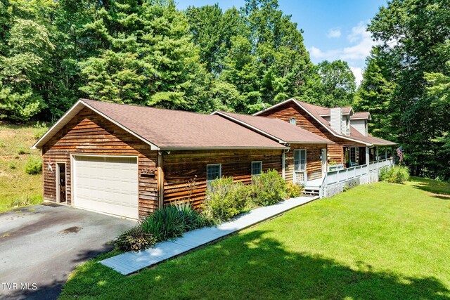 log-style house featuring a garage and a front yard