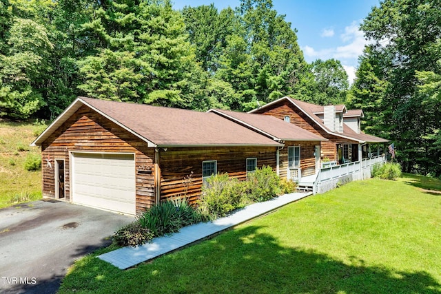 log-style house with aphalt driveway, roof with shingles, an attached garage, and a front lawn