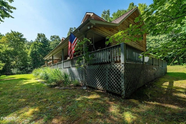 view of side of home featuring a yard