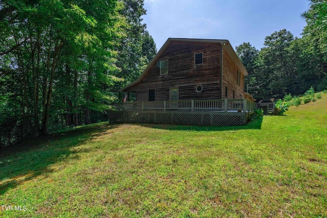 exterior space with a wooden deck and a yard