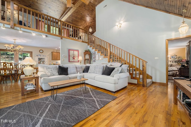 living room featuring wood ceiling, wood finished floors, stairs, high vaulted ceiling, and a notable chandelier