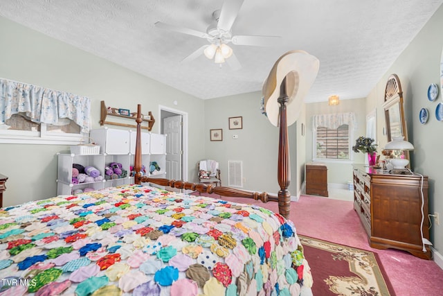 bedroom featuring carpet, visible vents, and a textured ceiling