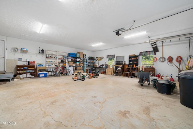 garage with a workshop area and a garage door opener