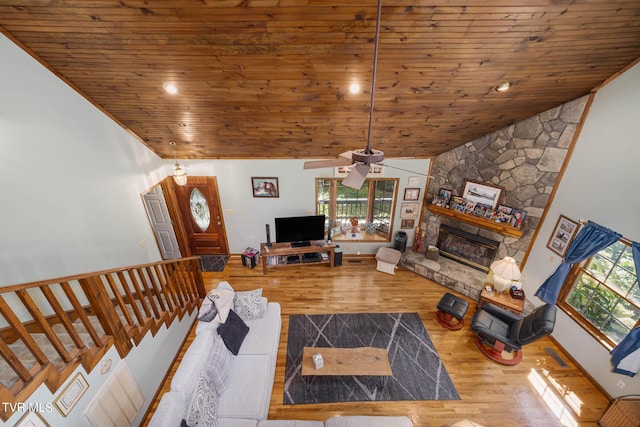 living room featuring baseboards, wood ceiling, wood finished floors, vaulted ceiling, and a fireplace