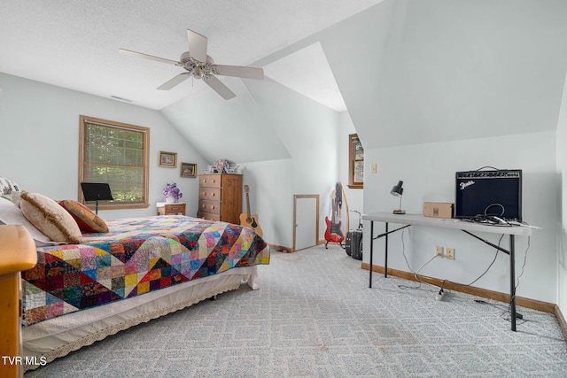 bedroom featuring lofted ceiling, ceiling fan, a textured ceiling, carpet flooring, and baseboards