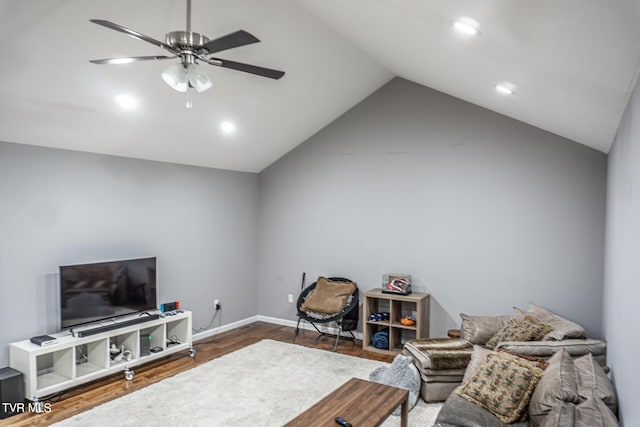 living area featuring vaulted ceiling, wood finished floors, a ceiling fan, and baseboards