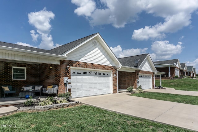 ranch-style house with an attached garage, brick siding, outdoor lounge area, concrete driveway, and a front lawn