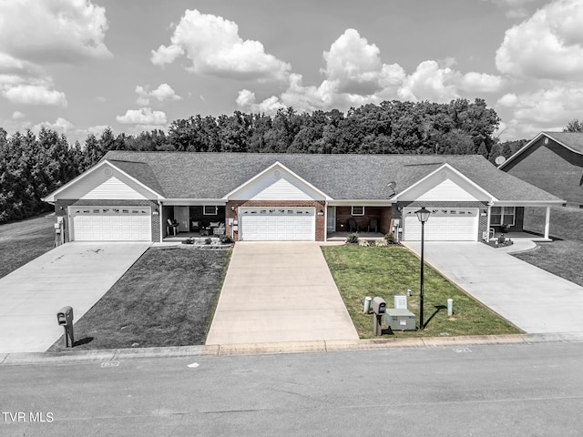 ranch-style house with brick siding, roof with shingles, a garage, driveway, and a front lawn