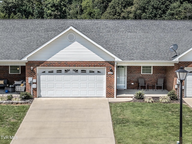 ranch-style house with brick siding, a shingled roof, covered porch, a front yard, and a garage