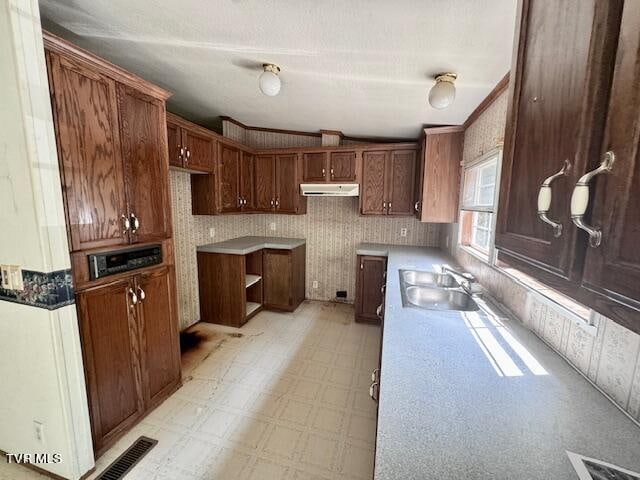 kitchen featuring light tile patterned floors and sink