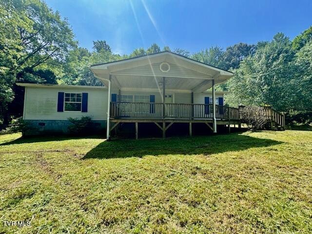 rear view of property with a yard