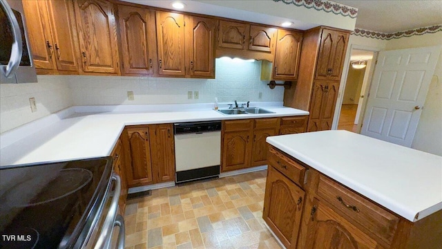 kitchen featuring stainless steel appliances, sink, light tile patterned floors, and tasteful backsplash