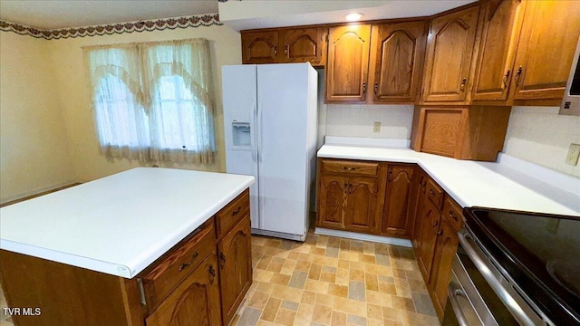 kitchen featuring white refrigerator with ice dispenser, stainless steel range with electric cooktop, light tile patterned floors, stainless steel range oven, and decorative backsplash