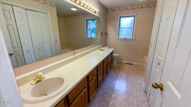 bathroom featuring tile patterned flooring, vanity, and toilet