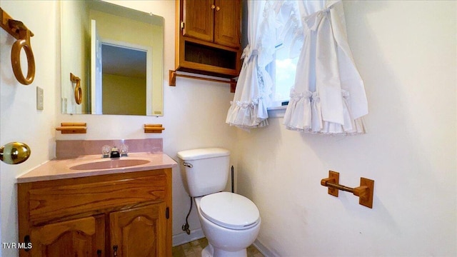 bathroom with toilet and vanity