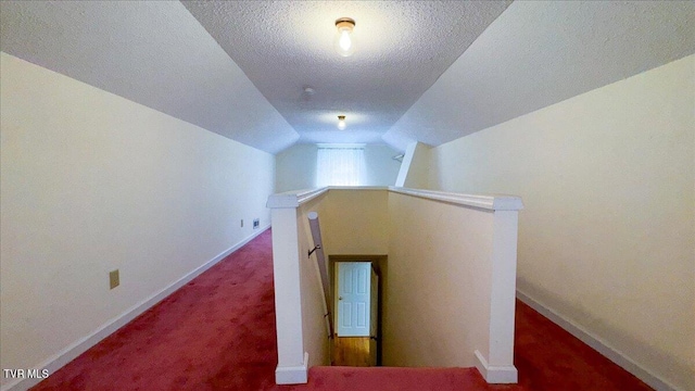 bonus room featuring vaulted ceiling, a textured ceiling, and carpet