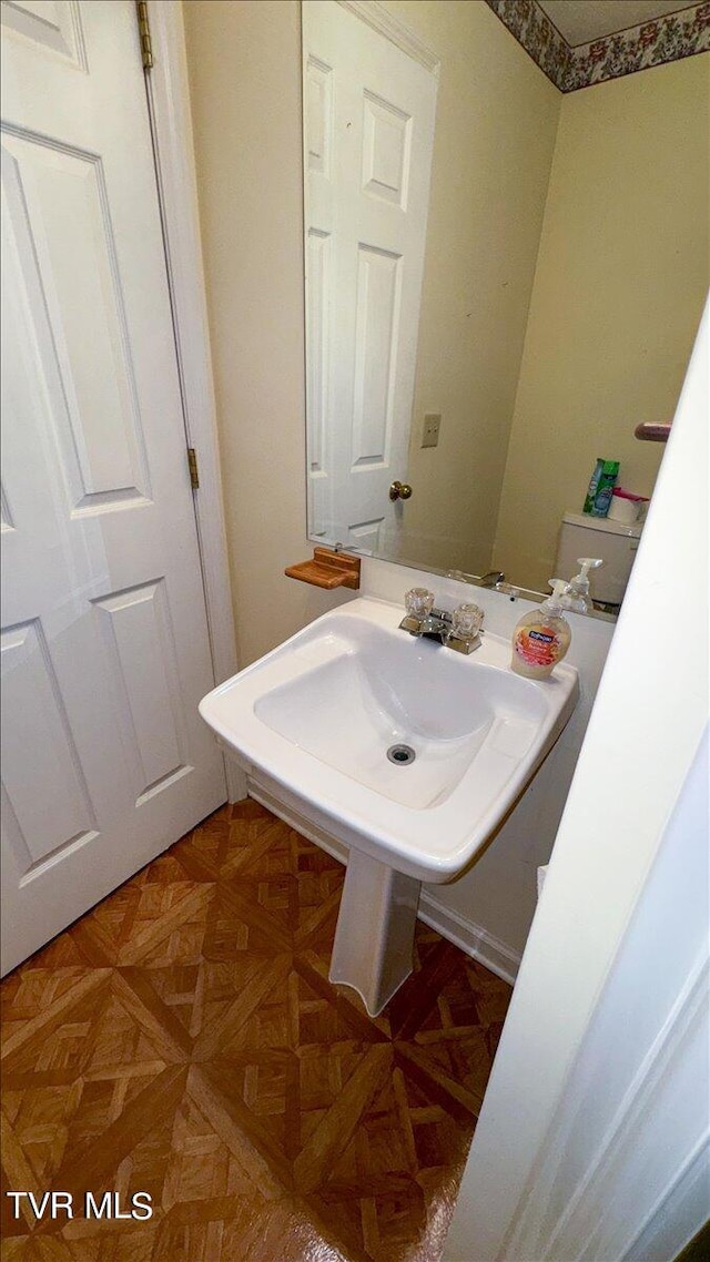 bathroom featuring parquet floors