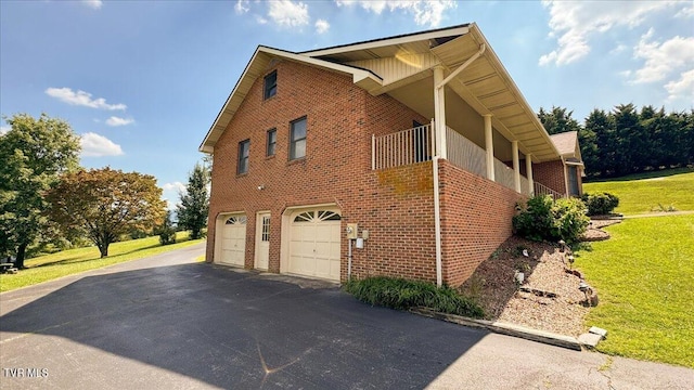 view of home's exterior featuring a lawn and a garage