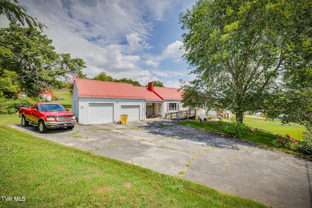 ranch-style house with a garage and a front yard