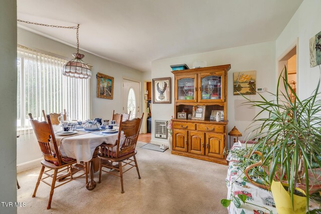 dining area featuring a wealth of natural light and light colored carpet