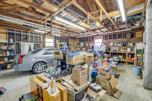 garage with a garage door opener and a workshop area