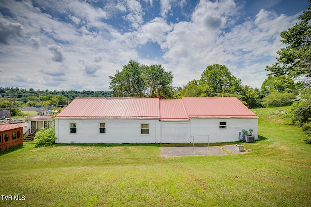 back of house with a yard, a patio area, and central AC unit