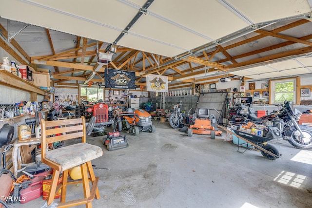 garage with a garage door opener and a workshop area