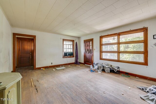 foyer featuring hardwood / wood-style flooring, a wealth of natural light, and cooling unit