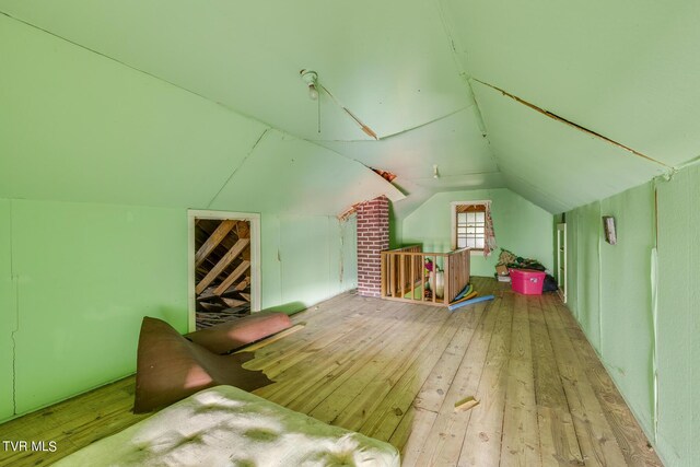 bonus room featuring vaulted ceiling and wood-type flooring