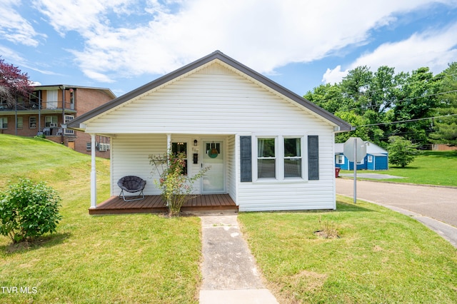 bungalow-style house with a porch and a front yard