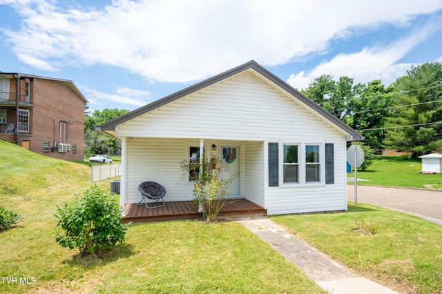 bungalow-style home with a front yard and covered porch