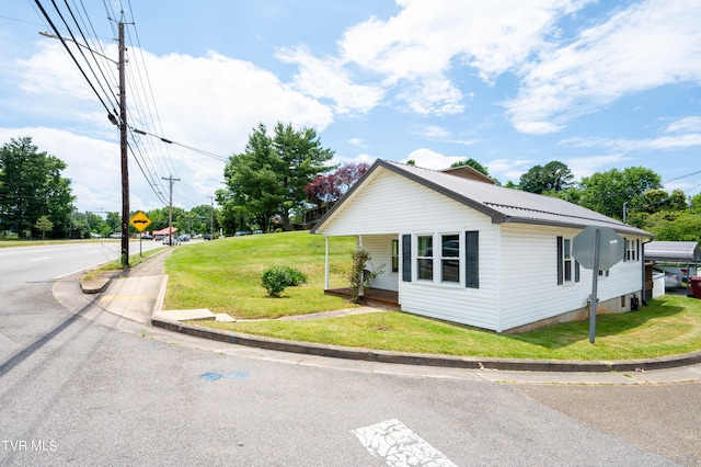 view of property exterior with a lawn