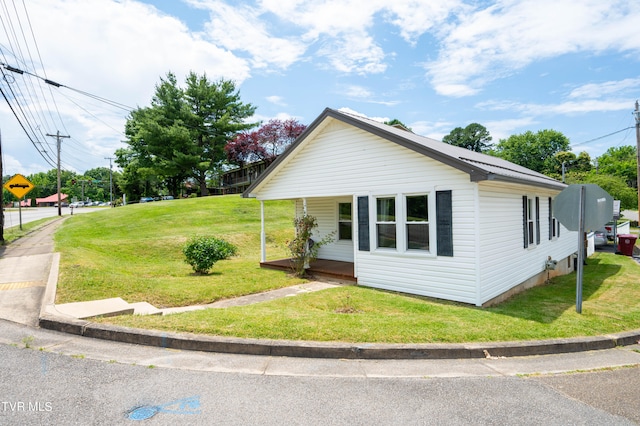 view of side of home featuring a yard