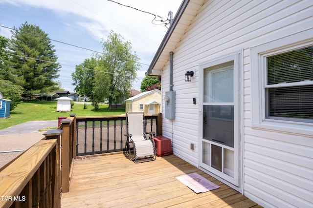 wooden deck with a lawn