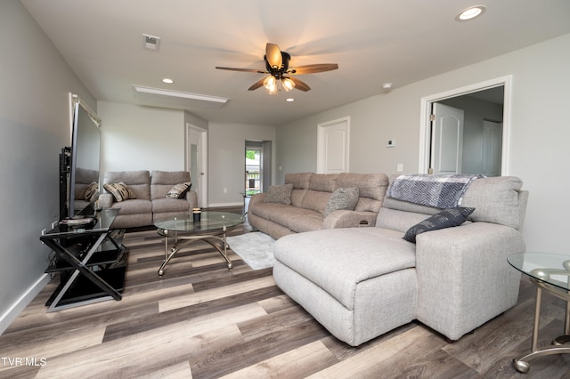 living room with light wood-type flooring and ceiling fan