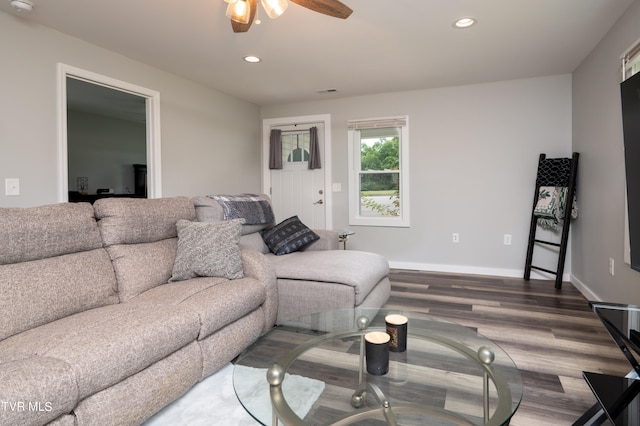 living room featuring ceiling fan and dark hardwood / wood-style floors